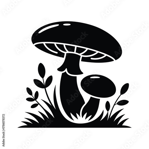 Stylized black and white silhouette of mushrooms and grass