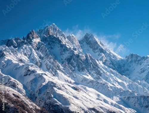 Dramatic Alpine Panorama, Snow-Capped Mountains, Intense Blue Sky, Sunlit Peaks With Blowing Snow, Rugged Winter Terrain, Clear Cold Air