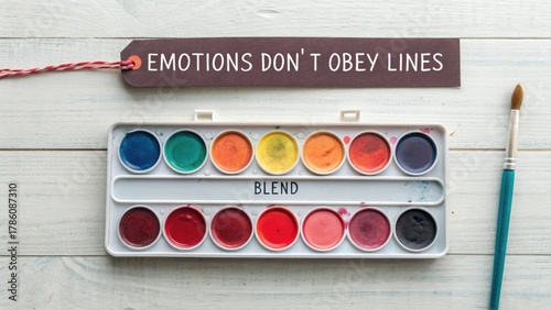 Flat Lay of Watercolor Palette Where Red Bleeds With Colors and Blend