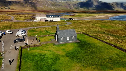 4k aerial drone footage of orbiting around famous Budakirkja church (black church)  in Snaefellsjoekull national park, Iceland. 