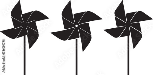 Three black pinwheel toys on sticks silhouette
