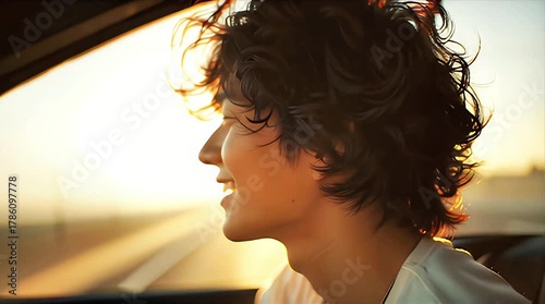 Sunset Glow: Curly-Haired Joy in Car Silhouette
