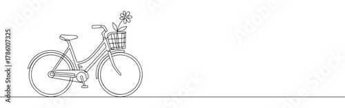 Continuous one line drawing of a bicycle with a flower in the basket. Concept of cycling, nature and healthy lifestyle