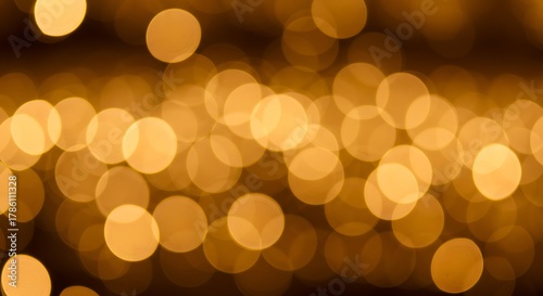 Abstract golden bokeh lights background with a soft focus effect, creating a warm and magical ambiance for festive occasions