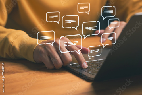 Fotografía Online communication and chat concept showing hands typing on laptop with digital message icons, representing social media, instant messaging, customer support, and digital conversation technology