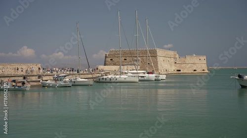 View of boats in Heraklion Venetian Port and Venetian Fortress Rocca a Mare on a sunny day, Heraklion, Crete, Greek Islands, Greece, Europe