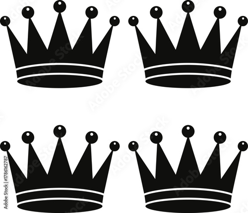 Four black crown icons arranged in a two-by-two grid, each featuring pointed spikes and topped with small spheres.
