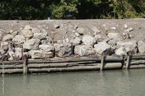 shoreline retaining wall rocks timber