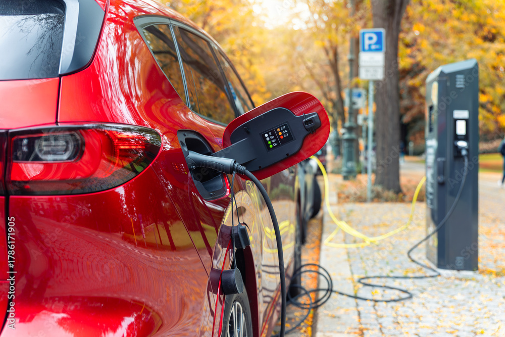 Φωτογραφία Close-up modern electric plug-in hybrid car SUV van parked   fast charger charging station point center street old European city