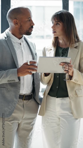 Video of business people working with digital tablet while discussing together in conference room at modern startup