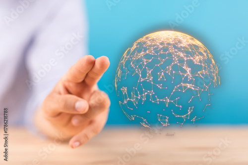 Hand reaching towards a glo...