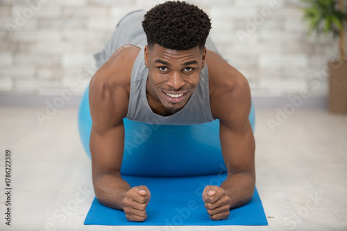 young man doing sport at home