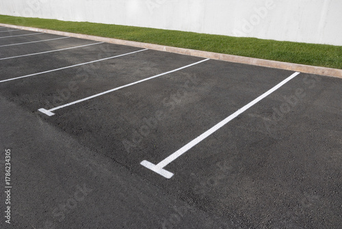 parking with asphalt surface and markings for cars.