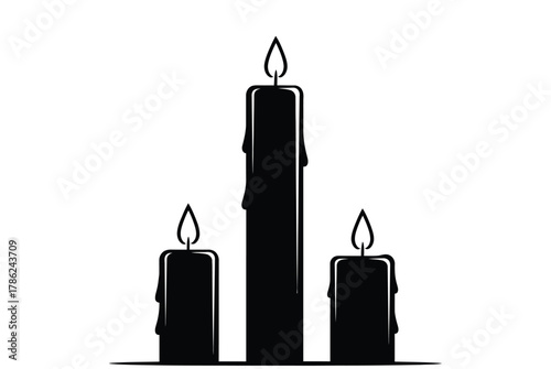 Three black candles with flames burning brightly against a white background.