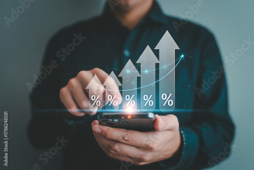 Increase profit growth rate concept businessman using smartphone with percentage graph chart rising up