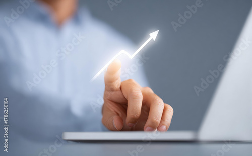 Optimistic businessman finger touching glowing arrow on chart. concept for business growth, financial success, investment, stock market, and technology development