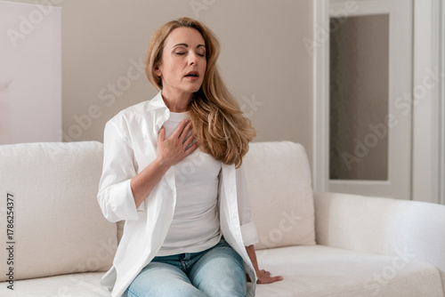 Mature woman experiences severe chest pain and difficulty breathing indoors