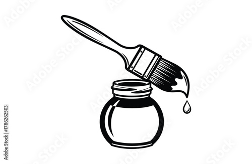 A paintbrush is dipping into an open ink bottle with a drop of ink falling.