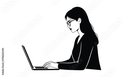 A woman wearing glasses is focused on typing on her laptop computer.