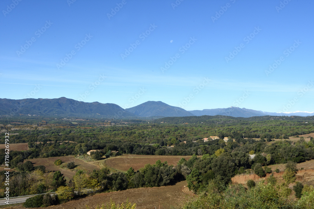 Fototapeta premium panoramic view of Monseny, Les Guilleries and the Unyar river, from the route of the Crosa volcano, Vilobir de Onyar, Girona province, Catalonia, Spain