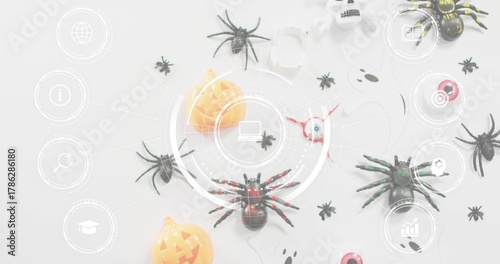 Showing red-accented black toy spider sitting centered on pale table, with Halloween props and HUD