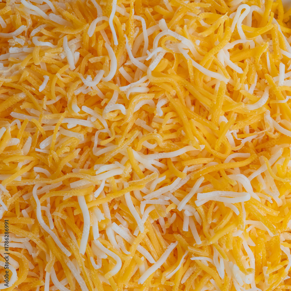 Fototapeta premium Close up macro of grated shredded cheese blend of Colby and Monterey jack cheeses