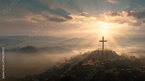 Cross on Mountain Peak at Sunrise with Sunbeams