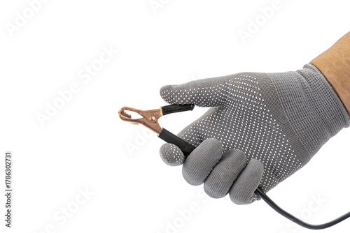 Papier peint Hand in gray glove holds copper alligator clip with black cable on white backgro