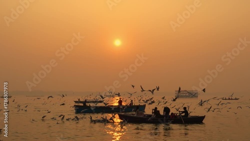 Tourists enjoy an early morning boat ride on the Ganga River in Varanasi as birds fly gracefully across the golden sky. A perfect mix of peace, culture, and spirituality in India’s holiest city.