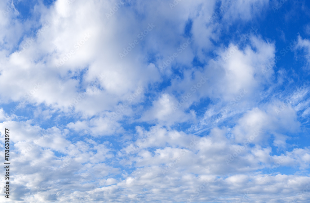 Naklejka premium Blue sky with scattered white clouds on a sunny day