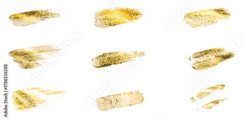 Artistic golden glitter brush stroke collection isolated on white background.