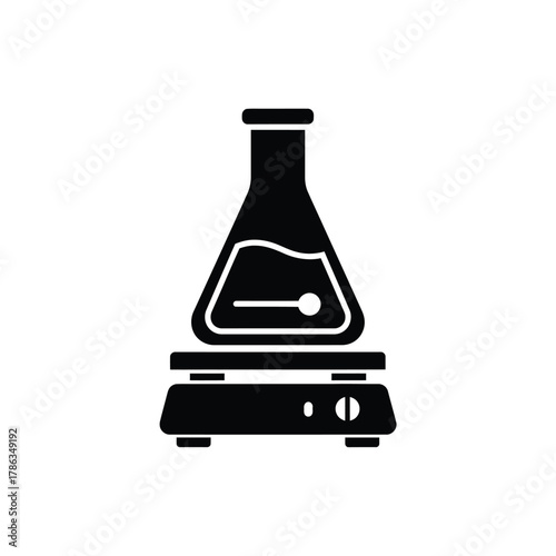 Black laboratory flask on a hot plate science beaker