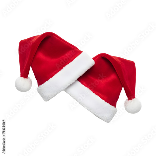 Two red santa hats with white trim isolated on transparent background