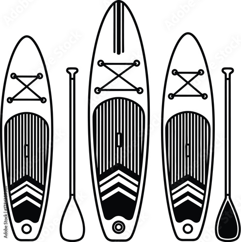 Three stand-up paddleboards and paddles are lined up for a day on the water.
