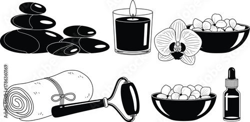 A collection of spa and relaxation items including hot stones, a candle, orchid, rolled towel, and massage roller.
