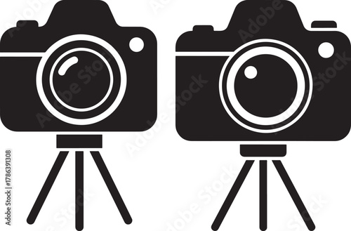 Two dslr cameras on tripods silhouette