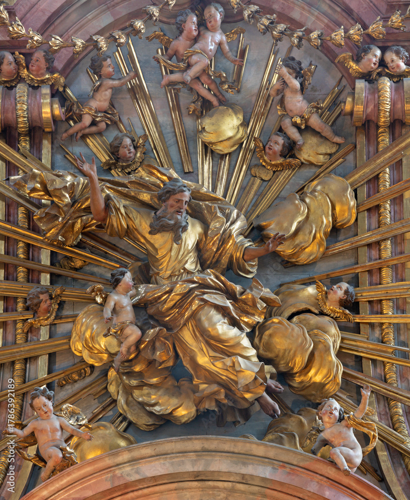 Fototapeta premium SALZBURG, AUSTIRA - SEPTEMBER 7, 2025: The carved polychrome statue of God the Creator from main altar in the church Franziskanerkirche by Johann Bernhard Fischer von Erlach (1709 - 1710)