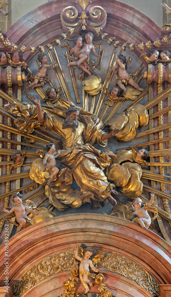Fototapeta premium SALZBURG, AUSTIRA - SEPTEMBER 7, 2025: The carved polychrome statue of God the Creator from main altar in the church Franziskanerkirche by Johann Bernhard Fischer von Erlach (1709 - 1710)