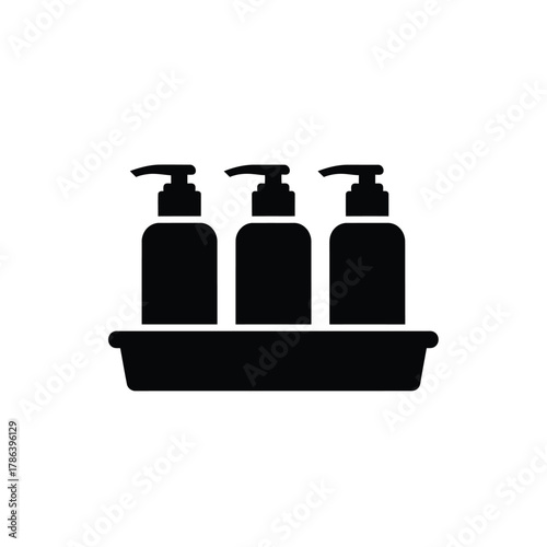 Three black pump bottles in a tray dispenser liquid