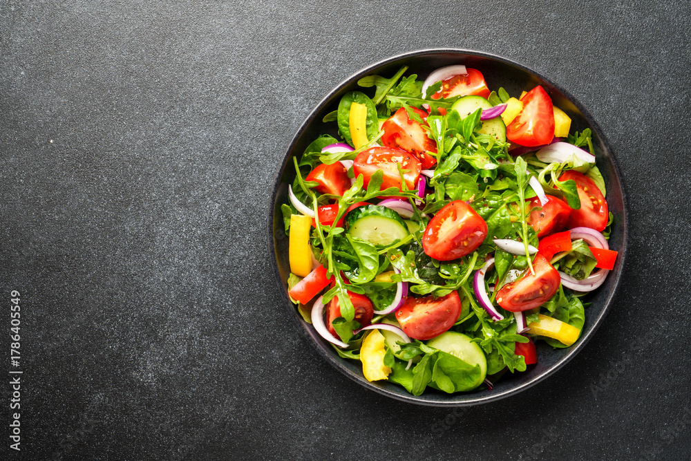 Fototapeta premium Fresh salad with leaves and vegetables.