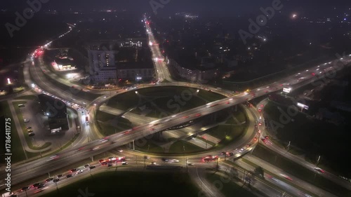 Night roundabout traffic, city circle aerial timelapse, rush hour