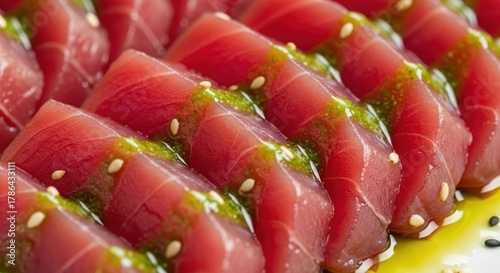 Delicious Sliced Tuna Tataki with Sesame Seeds and Green Sauce.