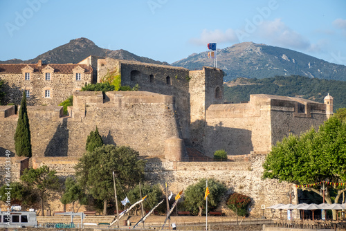 Fototapeta Naklejka Na Ścianę i Meble -  View of colourful Collioure, narrow streets and yellow, pink, orange houses, summer vacation destination town with historical buidings and beaches, Pyrenees-Orientales, France
