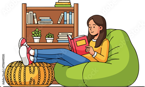 A young woman relaxes in a green beanbag chair, reading a book with her feet resting on an ottoman, a bookshelf behind her.