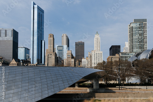 Chicago cityscape featuring iconic architecture against a cloudy sky on a sunny day.