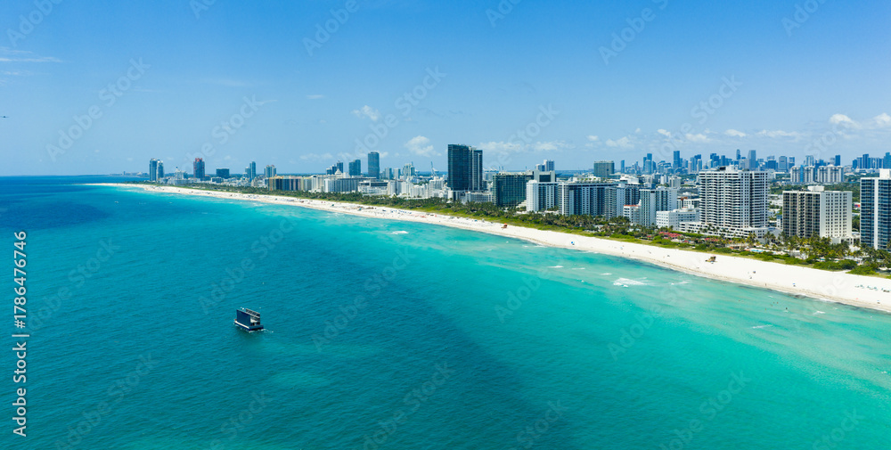 Fototapeta premium Drone aerial view of Miami sandy beach. Wide drone shot of Miami Beach and ocean.