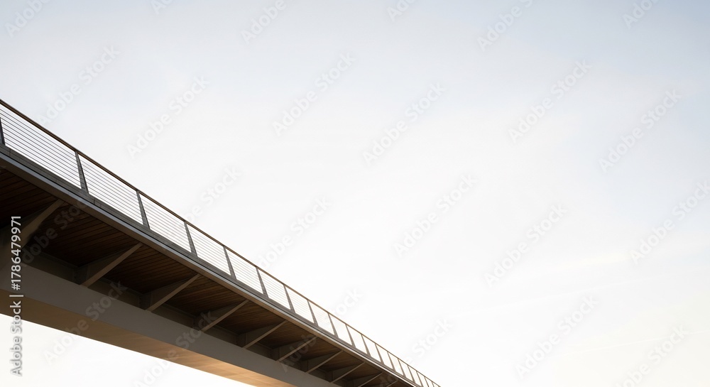 Obraz premium A modern pedestrian bridge railing against a pale sky