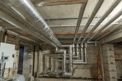 Industrial ventilation system with metallic ducts in a basement environment