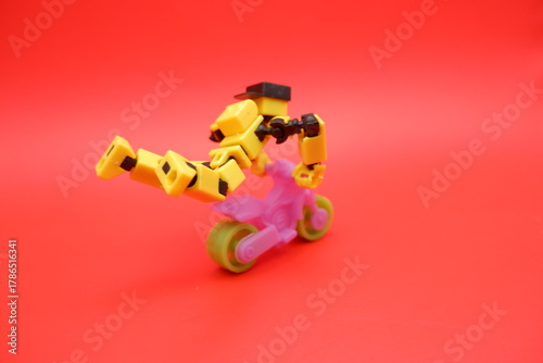Toy Action Figure Performing Stunt on Mini Motorcycle