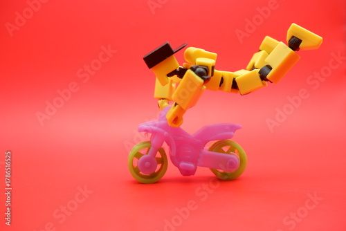 Toy Action Figure Performing Stunt on Mini Motorcycle